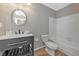 Stylish bathroom features a modern vanity with open storage and a tub/shower combination at 1712 Starling Dr # 101, Sarasota, FL 34231