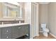 Bathroom with gray vanity, toilet and extra storage above the toilet at 1712 Starling Dr # 101, Sarasota, FL 34231