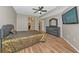 Spacious bedroom with a ceiling fan, television, and wood-look tile floor at 1712 Starling Dr # 101, Sarasota, FL 34231