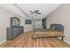 Well-lit bedroom with a ceiling fan, television, and stylish furniture at 1712 Starling Dr # 101, Sarasota, FL 34231