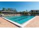 Sparkling community pool with clear blue water, surrounded by lounge chairs and manicured landscaping at 1712 Starling Dr # 101, Sarasota, FL 34231