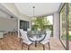 Well-lit dining room with large windows, stylish chandelier, and beautiful tile floors at 1712 Starling Dr # 101, Sarasota, FL 34231