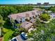Well-kept townhome featuring mature landscaping, a two-car garage, and proximity to community amenities at 1712 Starling Dr # 101, Sarasota, FL 34231