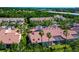 Attractive exterior showcases vibrant landscaping, mature palms and a red tile roof with well-maintained lawns at 1712 Starling Dr # 101, Sarasota, FL 34231