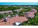 Attractive residential complex featuring well-maintained red tile roofs, mature trees, and lush landscaping in a community at 1712 Starling Dr # 101, Sarasota, FL 34231