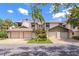 Attractive townhomes with garages and landscaping, creating curb appeal on a sunny day at 1712 Starling Dr # 101, Sarasota, FL 34231