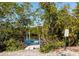 Community kayak launch point surrounded by dense tropical foliage with steps into the water. Kayak use only sign at 1712 Starling Dr # 101, Sarasota, FL 34231