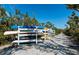 Community kayak storage rack near water access point on crushed shell path, lush tropical foliage surround at 1712 Starling Dr # 101, Sarasota, FL 34231