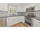 Charming kitchen featuring stainless appliances, ample cabinetry, and an attractive backsplash at 1712 Starling Dr # 101, Sarasota, FL 34231