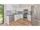 Modern kitchen with stainless steel appliances, white cabinets, and stylish backsplash at 1712 Starling Dr # 101, Sarasota, FL 34231