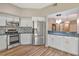 Bright kitchen with stainless steel fridge, modern appliances, and open breakfast bar to dining area at 1712 Starling Dr # 101, Sarasota, FL 34231