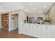 Convenient kitchenette featuring white cabinetry, modern appliances, and adjacent bookshelf access at 1712 Starling Dr # 101, Sarasota, FL 34231
