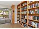 Library featuring extensive shelving and collection, flooded with natural light, with an outdoor view at 1712 Starling Dr # 101, Sarasota, FL 34231