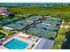 Aerial view of the community offering multiple tennis courts, a pool and a lake, perfect for an active lifestyle at 1712 Starling Dr # 101, Sarasota, FL 34231
