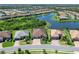 Beautiful aerial view of homes along a pond in a well-planned community with manicured lawns and mature landscaping at 17820 Waterville Pl, Lakewood Ranch, FL 34202
