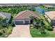 A luxurious single-Gathering home boasting a three-car garage and paver driveway in a landscaped community at 17820 Waterville Pl, Lakewood Ranch, FL 34202