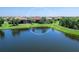 Serene aerial image of a lakeside home with a screened-in pool and beautifully landscaped backyard at 17820 Waterville Pl, Lakewood Ranch, FL 34202