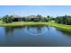 Scenic aerial view showcasing a home with a lush backyard bordering a peaceful lake, perfect for waterfront living at 17820 Waterville Pl, Lakewood Ranch, FL 34202