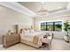 Bright bedroom featuring a large window with outside views and decorative lighting fixture at 17820 Waterville Pl, Lakewood Ranch, FL 34202
