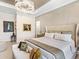 Bright bedroom featuring a large bed with decorative pillows and painting on the wall at 17820 Waterville Pl, Lakewood Ranch, FL 34202