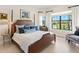 Bright bedroom with a large window offering serene outdoor views and a cozy seating area at 17820 Waterville Pl, Lakewood Ranch, FL 34202