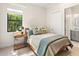 Cozy bedroom with a comfortable bed, bedside table, and a view to the outside at 17820 Waterville Pl, Lakewood Ranch, FL 34202