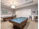 Billiard room featuring two pool tables, stylish decor, and comfortable seating at 17820 Waterville Pl, Lakewood Ranch, FL 34202