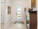 Inviting foyer features a glass door, tiled floor and beautiful decorations at 17820 Waterville Pl, Lakewood Ranch, FL 34202