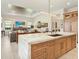 Gourmet kitchen featuring a stone island with seating, custom cabinets, and stainless steel appliances at 17820 Waterville Pl, Lakewood Ranch, FL 34202