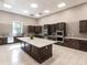 Community kitchen with stainless steel appliances, ample countertop space, and dark wood cabinets at 17820 Waterville Pl, Lakewood Ranch, FL 34202