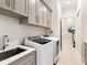 Convenient laundry room with modern appliances, ample storage cabinets, and stylish tiled floors at 17820 Waterville Pl, Lakewood Ranch, FL 34202