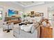 Comfortable living room features a modern fireplace, recessed lighting, and a wall of curated artwork at 17820 Waterville Pl, Lakewood Ranch, FL 34202
