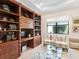 Comfortable living room features stylish decor, plenty of natural light, and modern shelving at 17820 Waterville Pl, Lakewood Ranch, FL 34202