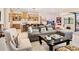 Open-concept living space with view of kitchen, island seating, and sliding glass doors to outdoor living area at 17820 Waterville Pl, Lakewood Ranch, FL 34202