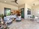 Spacious outdoor patio with elegant furniture, travertine flooring, and seamless access to indoor living spaces at 17820 Waterville Pl, Lakewood Ranch, FL 34202
