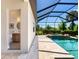 Elegant pool area offering a seamless transition from indoor powder room to outdoor entertainment space at 17820 Waterville Pl, Lakewood Ranch, FL 34202