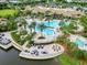 An inviting zero entry pool with lounge chairs, palm trees, and a lake view at 17820 Waterville Pl, Lakewood Ranch, FL 34202