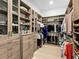 Walk-in closet featuring plenty of storage and shelves for clothes and shoes at 17820 Waterville Pl, Lakewood Ranch, FL 34202