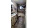 Traditional bathroom featuring a vanity with black hardware, bathtub, and tile flooring at 1810 Rudder Dr, Valrico, FL 33594