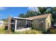 Enclosed patio with screens, offering a view of the backyard and a shaded area for relaxation and entertainment at 1810 Rudder Dr, Valrico, FL 33594