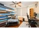 Comfortable bedroom with a ceiling fan, computer desk, and stylish wood accent wall at 1813 5Th W St, Palmetto, FL 34221
