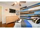 This bedroom features a stylish accent wall, ceiling fan, and sports themed decor at 1813 5Th W St, Palmetto, FL 34221