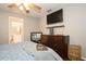 Neutral bedroom featuring ceiling fan, wood floors, and dresser at 1813 5Th W St, Palmetto, FL 34221