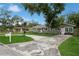 Charming single-story home with a gray exterior, well-manicured lawn, and a long driveway at 1813 5Th W St, Palmetto, FL 34221
