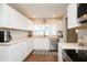 Bright kitchen with white cabinetry, stainless steel appliances, and neutral countertops at 1813 5Th W St, Palmetto, FL 34221