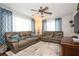 Spacious seating area with blue accent pillows and a ceiling fan at 1813 5Th W St, Palmetto, FL 34221