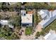 Modern home features rooftop solar panels, turf lawn, outdoor recreational space, and stylish design at 216 Archer Way, Anna Maria, FL 34216