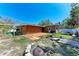 Backyard with patio area, faux grass, and landscaping at 216 Archer Way, Anna Maria, FL 34216