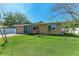 Charming single-story home with a brick driveway, lush green lawn, and well-maintained landscaping at 216 Archer Way, Anna Maria, FL 34216