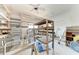 Garage featuring shelving, work benches, and a toilet presenting a functional and customizable area at 216 Archer Way, Anna Maria, FL 34216
